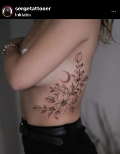 a woman's stomach with flowers and a crescent tattoo on her side, in black ink