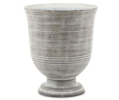 a large gray vase sitting on top of a white table