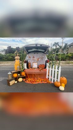 the back of a van is decorated with pumpkins and other things to decorate it