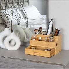 an assortment of items is displayed in front of a mirror and vases on a dresser