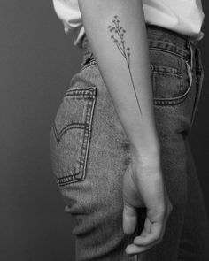 a woman with a flower tattoo on her arm