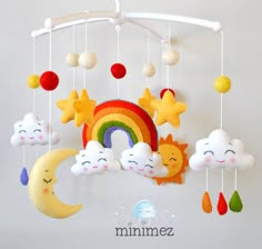 a mobile with clouds, rainbows and stars hanging from it