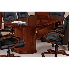 an oval conference table with black leather chairs