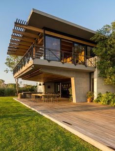 an image of a modern house that looks like it is built on the side of a hill