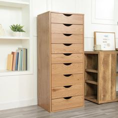 a wooden cabinet sitting next to a book shelf