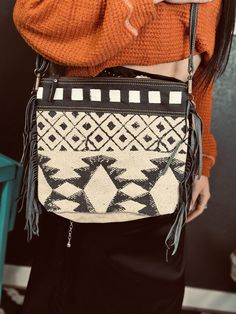 Elevate your style with The Whitehouse Road Purse! This rustic aztec print bag features black and white design, fringe details, and light blue accents for a cute, fun look. Carry all your essentials in style and add a touch of boho-chic to any outfit. Adjustable Strap Black And White Design, Blue Accents, Aztec Print, Printed Bags, White Design, Western Fashion, Fashion Boutique, Boho Chic, Light Blue