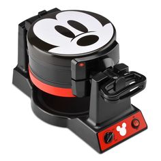 the mickey mouse waffle maker is black and white with red trimmings on it