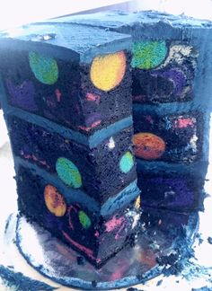 there is a cake that has been decorated with different colors and shapes on the side