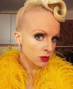 a woman with blonde hair and bright yellow feathers