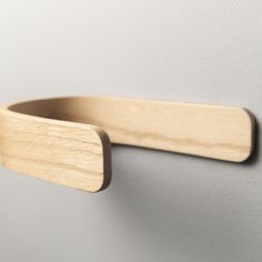 a wooden toothbrush holder hanging on the wall