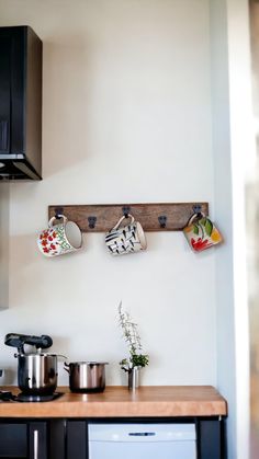 pots and pans are hanging on the wall above the kitchen counter, which also has an oven