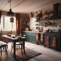 an old fashioned kitchen with wooden floors and walls, along with green cabinets and plaid curtains