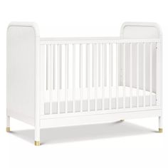 a white crib with gold legs and no mattress in the bottom half, against a white background