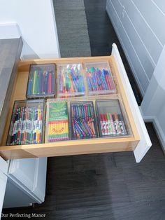 the drawers are filled with many different colored pencils