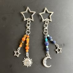 two star and moon charms with beads on them