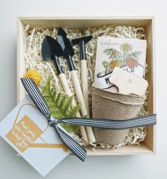 an open box with utensils and other items in it on a white surface