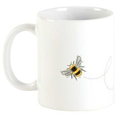 a white coffee mug with a drawing of a bee on it's front and side