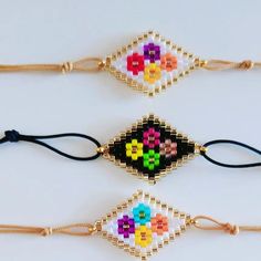 three beaded bracelets with different designs on them