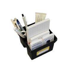 a black plastic container filled with lots of papers and office supplies on top of a white background