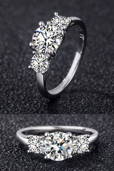 three stone engagement ring with diamond accents on the side and an open band around it