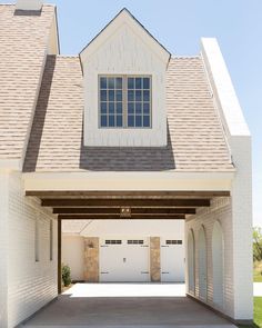 an empty garage with two white doors and windows