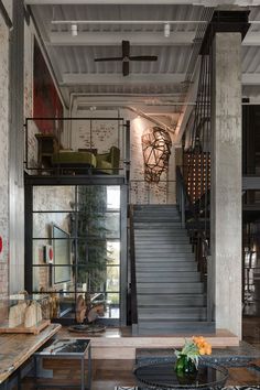 a living room filled with furniture and a staircase