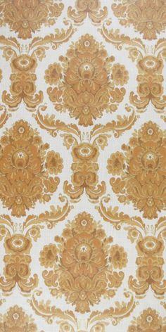 an old wallpaper with gold and white designs on it's surface, as well as the background