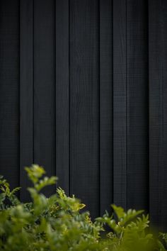 a clock on the side of a wooden building