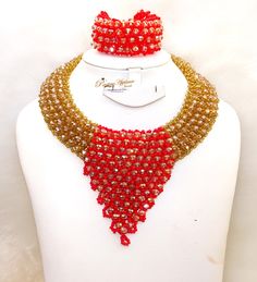 Cheap Sales Blue & Gold Peach African Nigerian Necklace Jewellery Fashion Set  Complete Set is Necklace Earring and bracelet Wedding Party Bridal Special Occasion This detailed Jewellery set makes you stand out elegantly in any special occassion, it's all about glamour and uniqueness.  Buying more that 1 Jewellery set, we offer wholesale and bulk prices for all our jewellery. Red Beaded Jewelry Sets For Celebration, Red Round Beads Bridal Necklace For Party, Red Bridal Necklace With Round Beads For Party, Red Bridal Necklace With Polished Beads For Party, Red Crystal Bridal Necklace For Party, Red Crystal Party Necklace, Multicolor Gold Beaded Jewelry For Wedding, Red Adjustable Round Jewelry Sets, Elegant Red Beaded Bridal Necklace