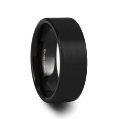 a black wedding band with an inscription on it