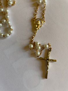 "SALE Beautiful Vintage Rosary Beads, White/Gold small 4mm round pearls, and small beads. NO previous owner, rosaries are new. PLEASE READ BELOW, VINTAGE DARKENING ON CRUCIFIX. PLEASE LOOK AT THE VIDEO. VINTAGE: These rosaries because they are Vintage have a dark vintage marks color on crucifix, please look at picture closely. PRICE ALREADY REFLECTS DARK SPOTS VINTAGE MARKS. NO RETURNS, NO EXCHANGES. Perfect gift for Baby Baptisms, First Communion, or Confirmations. Sent on cute white sheer orga White Crucifix Pearl Necklace As A Gift, Gold Pearl Jewelry For Baptism, Pearl Rosary With 8mm Beads As Gift, Rosary Bracelet With 8mm Round Beads For Baptism, Pearl Rosary Bracelet With 8mm Round Beads, Pearl Rosary With Round Beads As Gift, Vintage White Rosary As A Gift, White Pearl Crucifix Necklace, Spiritual Pearl Jewelry For Baptism