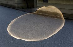 the shadow of a skateboarder is seen in front of a house