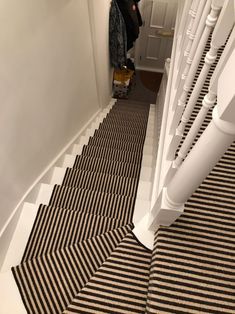 a black and white striped carpet on the stairs