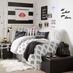 a bedroom with black and white decor and red lips on the wall above the bed