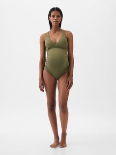 Soft, stretch maternity one-piece swimsuit.  Wrap-style V-neck.  Adjustable tank straps.  Tie at back.  This one-piece is made with 83% recycled polyester.  Less waste in the world.  More great swimsuits for you.  Please note: Maternity styles cannot be returned in store.  Please enjoy free returns by mail.  Choose your maternity Swimsuit For Pregnant Women, Summer Swimwear By Gap, Gap Summer Swimwear For The Pool, Gap Summer Swimwear For Pool, Summer Pool Swimwear By Gap, Fitted Sleeveless Maternity Swimwear, Gap Stretch Swimwear For Beach, Fitted Gap Swimwear For The Beach, Gap Swimwear For Summer Pool Season