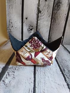 a small purse sitting on top of a wooden table next to a white wall with peeling paint