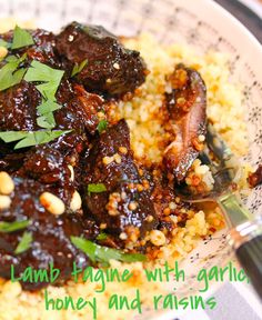 a plate full of food that includes meat, rice and garnished with parsley