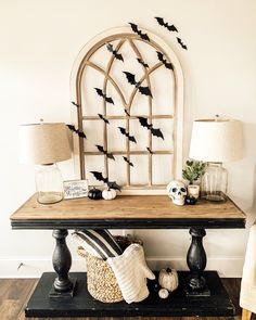 a wooden table topped with lots of halloween decorations