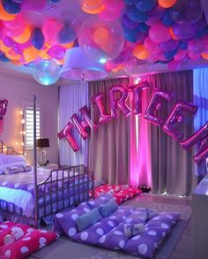 a bedroom decorated with balloons and bedding