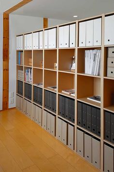 a room filled with lots of books and filing cabinets next to a wall full of file folders