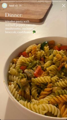 a white bowl filled with pasta and vegetables