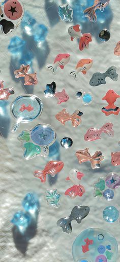 many different colored fish and bubbles floating in the water