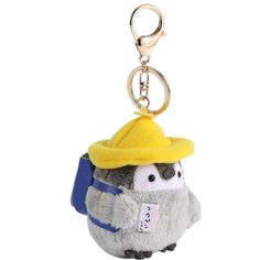 a stuffed animal keychain with a yellow hat on it's head and a blue