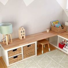 there is a shelf with baskets and toys on it next to a rug in the room