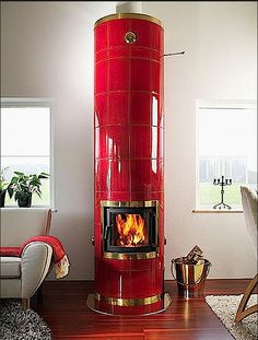 a living room filled with furniture and a fire place in the middle of the room