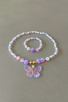 Butterfly necklace for girl purple necklace for children butterfly charm sweet necklace cute pendant butterfly gift for kids party favors This delightfully cute kids butterfly necklace and bracelet set is perfect for your little one! Constructed with an elastic cord, it is both easy and safe for your child to put on and take off. The purple and white beads, paired with the Butterfly charm, make this necklace the perfect accessory for your kid. Item Details *Material: Acrylic, Rice beads, Elastic Jewelry For Girls, Adjustable Purple Jewelry For Birthday, Purple Hypoallergenic Jewelry For Birthday, Whimsical Purple Necklace For Gift, Whimsical Purple Jewelry For Gifts, Cute Handmade Purple Jewelry, Adjustable Butterfly Necklace For Gift, Cute Butterfly Necklace For Gift, Butterfly Charm Jewelry For Birthday