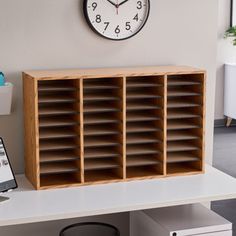 a clock mounted to the side of a wall next to a wooden shelf filled with books