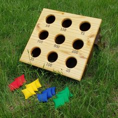 a wooden board game sitting in the grass