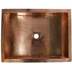 a square copper sink with a hole in the middle and an oval design on top