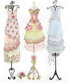 three dresses on mannequins with flowers and ribbons